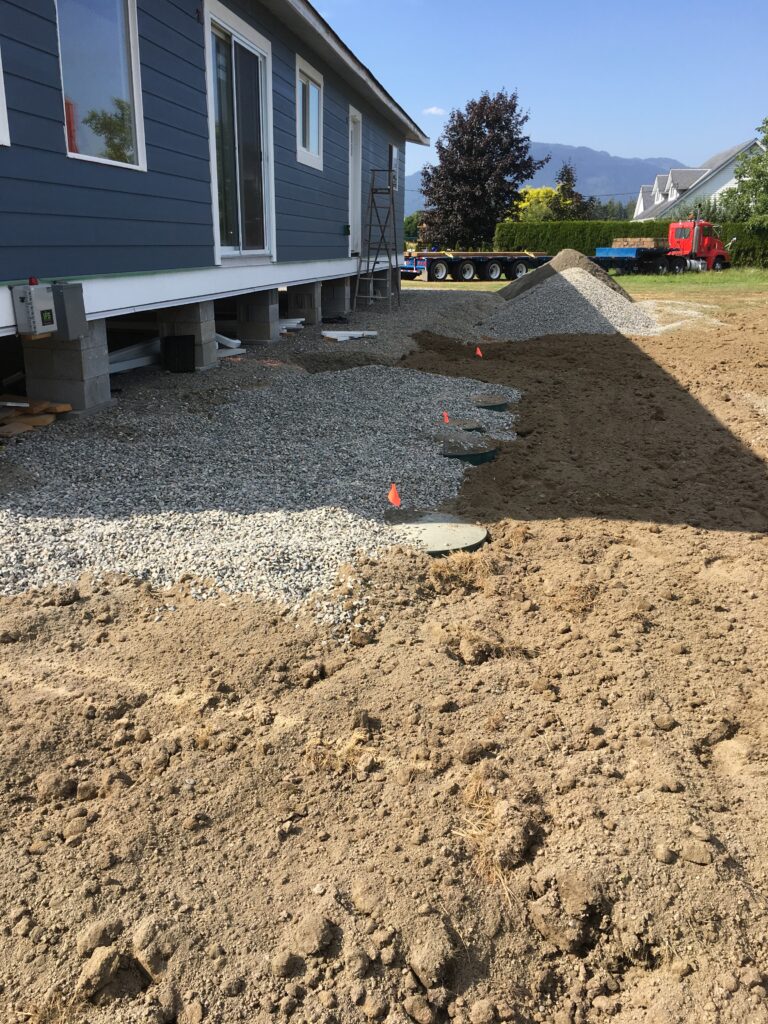 Excavator preparing a residential building site in the Fraser Valley