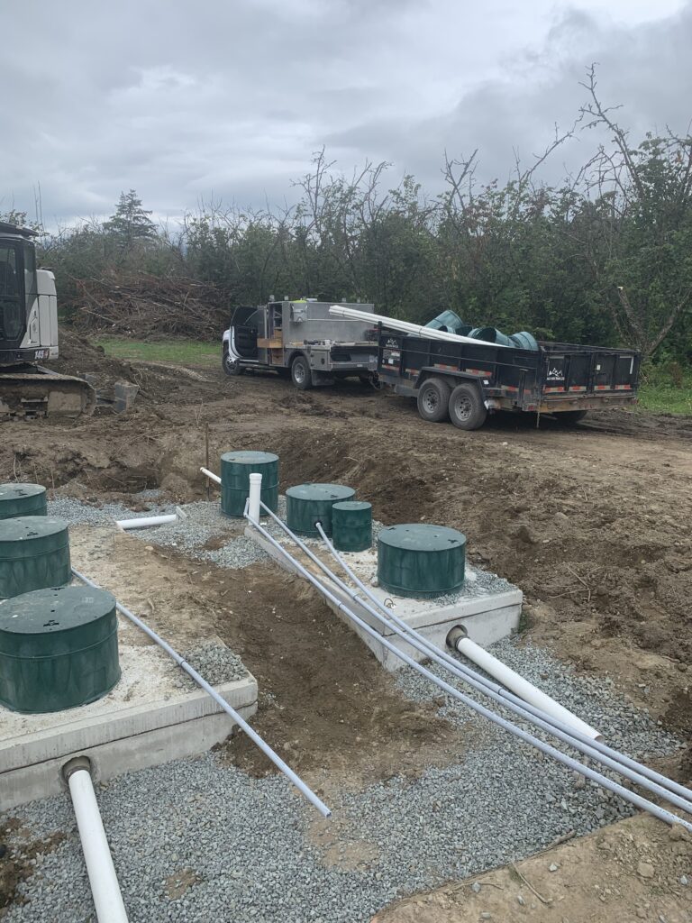 Excavator preparing a Dewdney acreage for septic tank installation