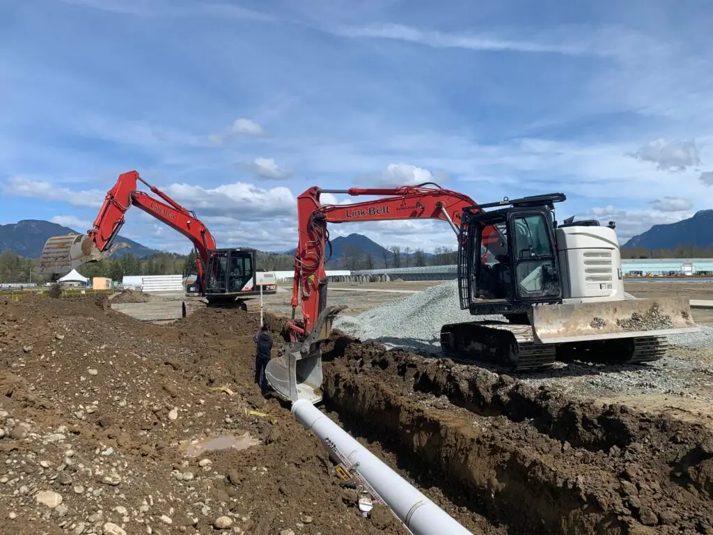 Excavator preparing a Delta property for septic system installation