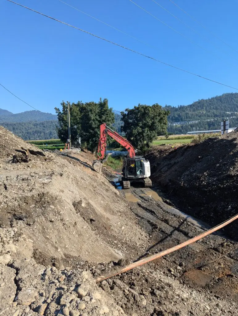 Excavator preparing a Merritt property for septic system installation