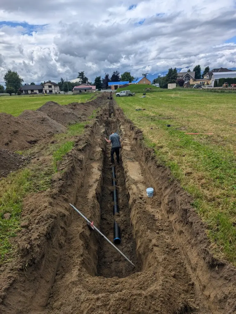 Excavator completing site work on a rural acreage
