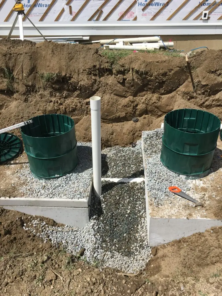 Excavator preparing a sloped Ryder Lake property for septic installation