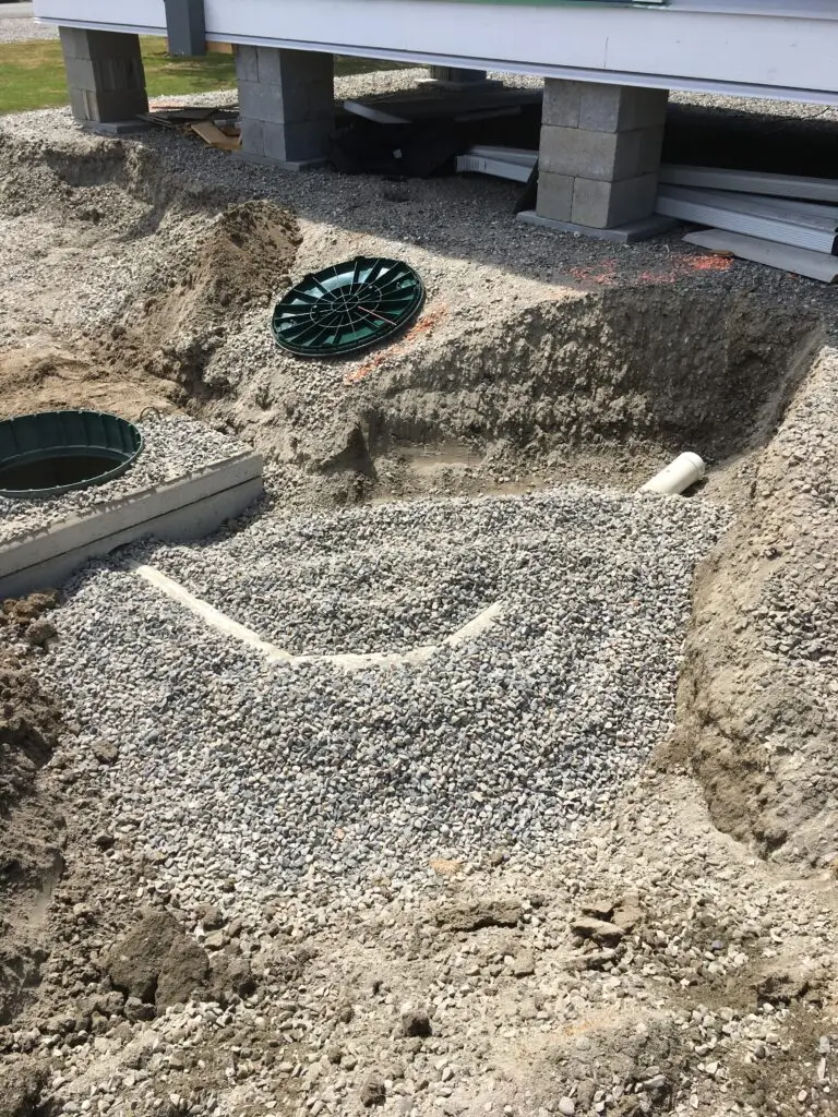 Excavator preparing a Laidlaw property for septic system installation