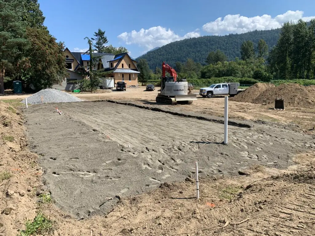 Excavator preparing a residential building site in the Fraser Valley